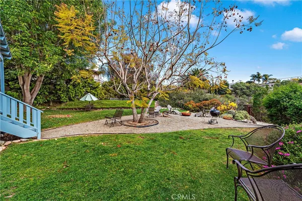 a view of backyard with swimming pool and green space