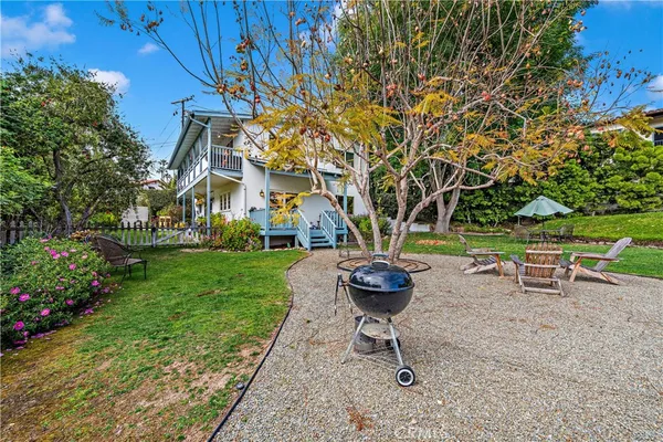 a view of a backyard with table and chairs