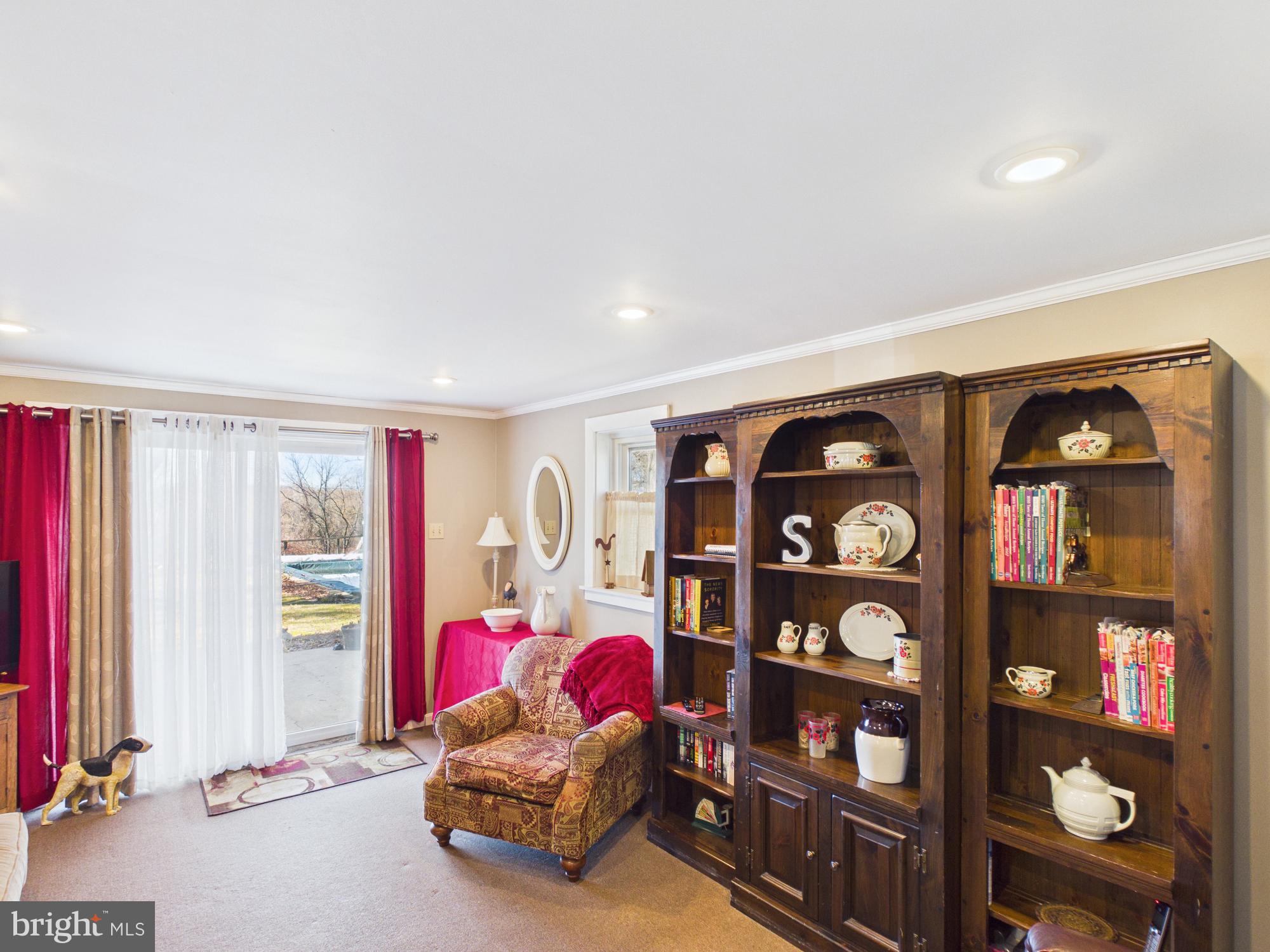 2175 River Road Washington Boro, PA 17582 - Photo 11 of 25 a living room with furniture a bookshelf and a window