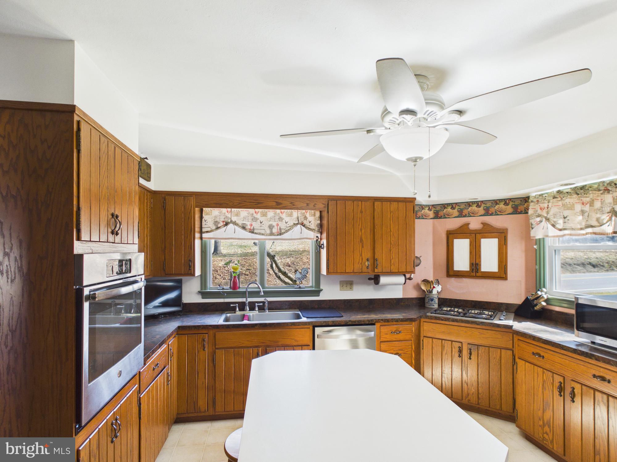 2175 River Road Washington Boro, PA 17582 - Photo 9 of 25 a kitchen with stainless steel appliances granite countertop a sink window and cabinets