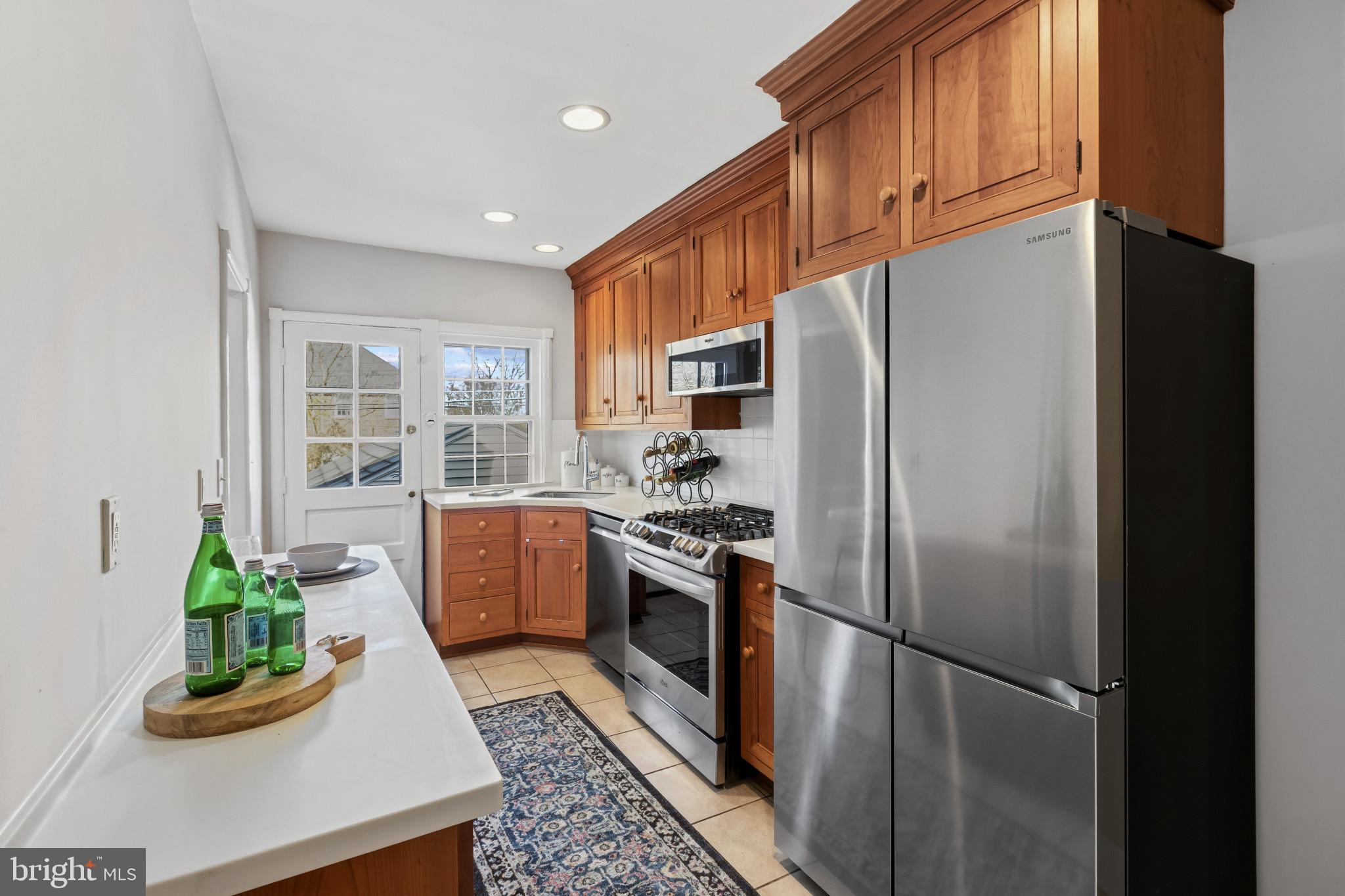 86 Dunkirk Road Baltimore, MD 21212 - Photo 12 of 52 a kitchen with stainless steel appliances granite countertop a refrigerator a stove a sink and a window
