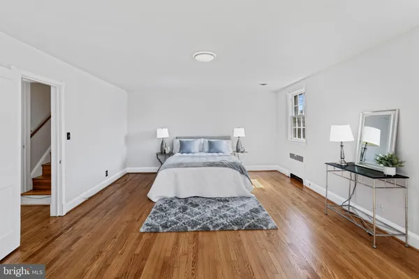 a bedroom with a bed and painting on the wall
