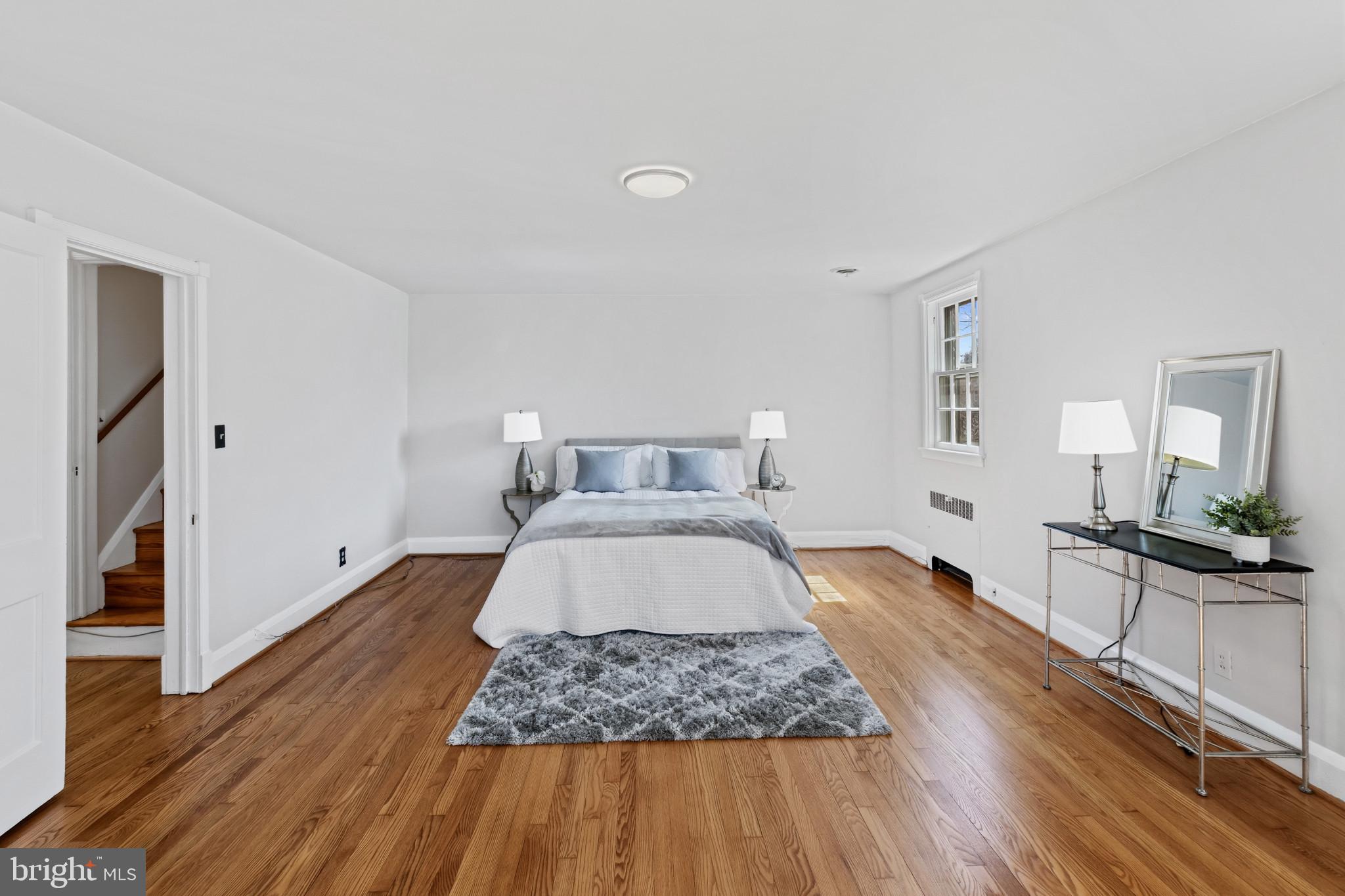86 Dunkirk Road Baltimore, MD 21212 - Photo 14 of 52 a bedroom with a bed and wooden floor