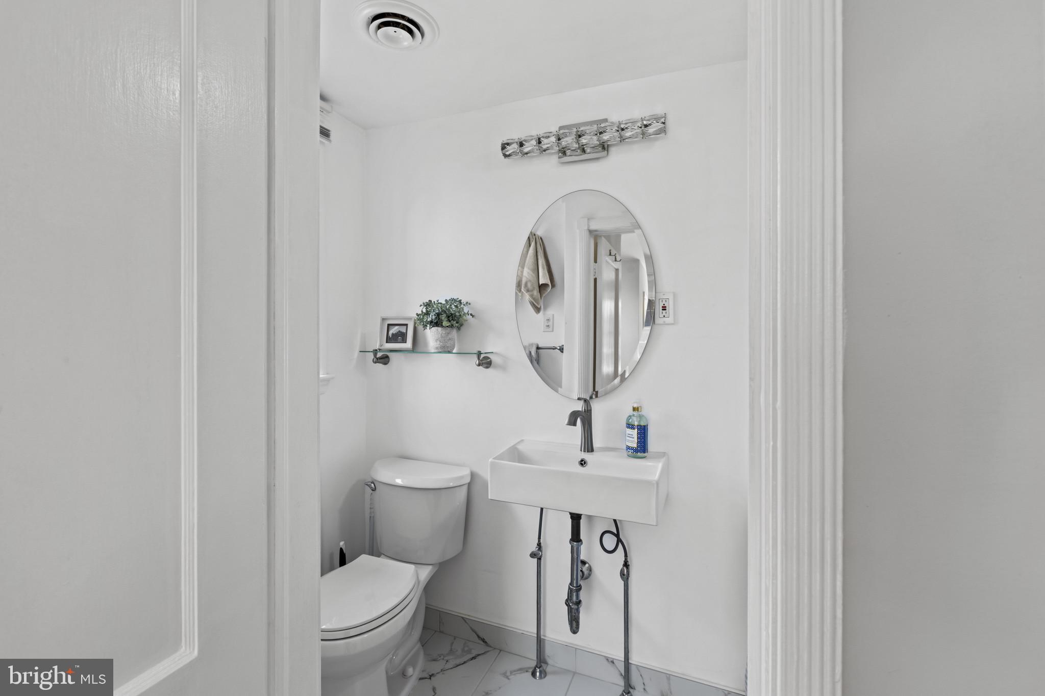86 Dunkirk Road Baltimore, MD 21212 - Photo 18 of 52 a bathroom with a toilet sink and mirror