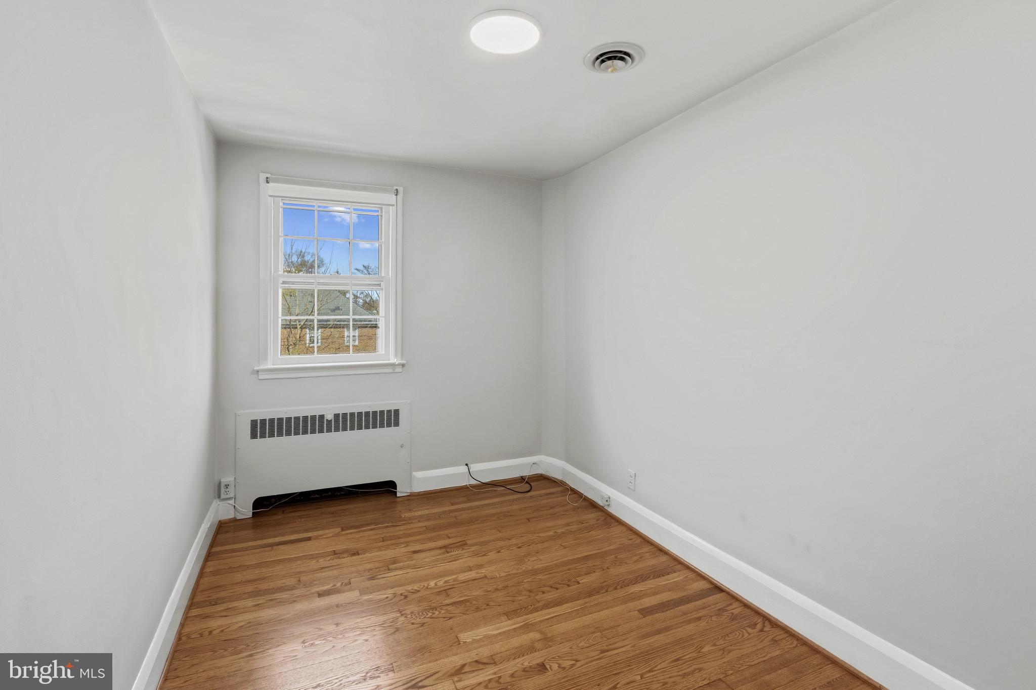 86 Dunkirk Road Baltimore, MD 21212 - Photo 24 of 52 a view of empty room with wooden floor and fan
