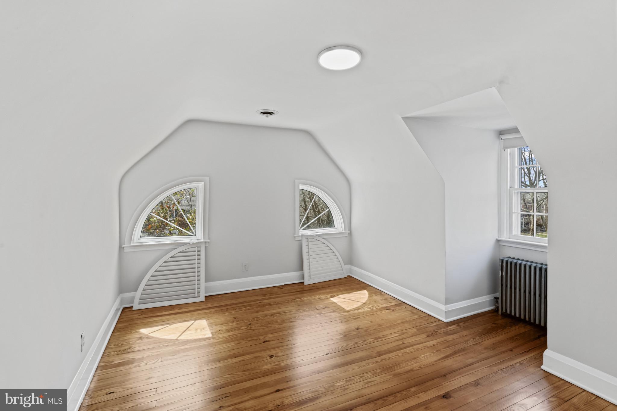 86 Dunkirk Road Baltimore, MD 21212 - Photo 27 of 52 an empty room with wooden floor and windows