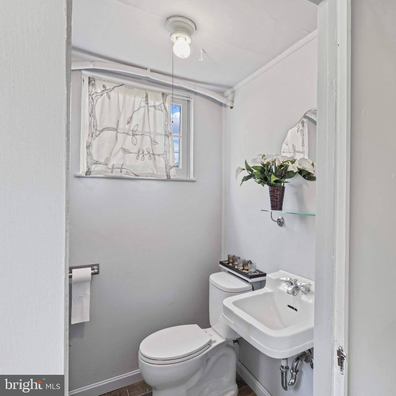 86 Dunkirk Road Baltimore, MD 21212 - Photo 34 of 52 a bathroom with a sink mirror and toilet