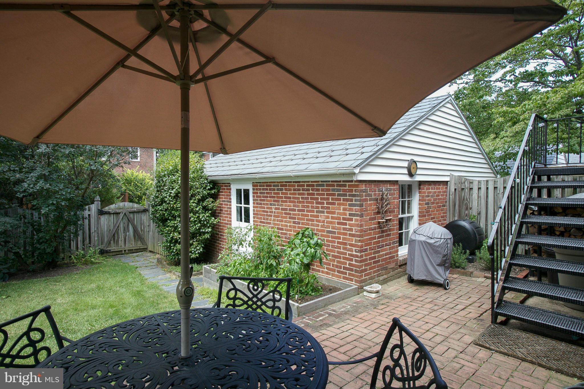 86 Dunkirk Road Baltimore, MD 21212 - Photo 39 of 52 a backyard of a house with table and chairs under an umbrella