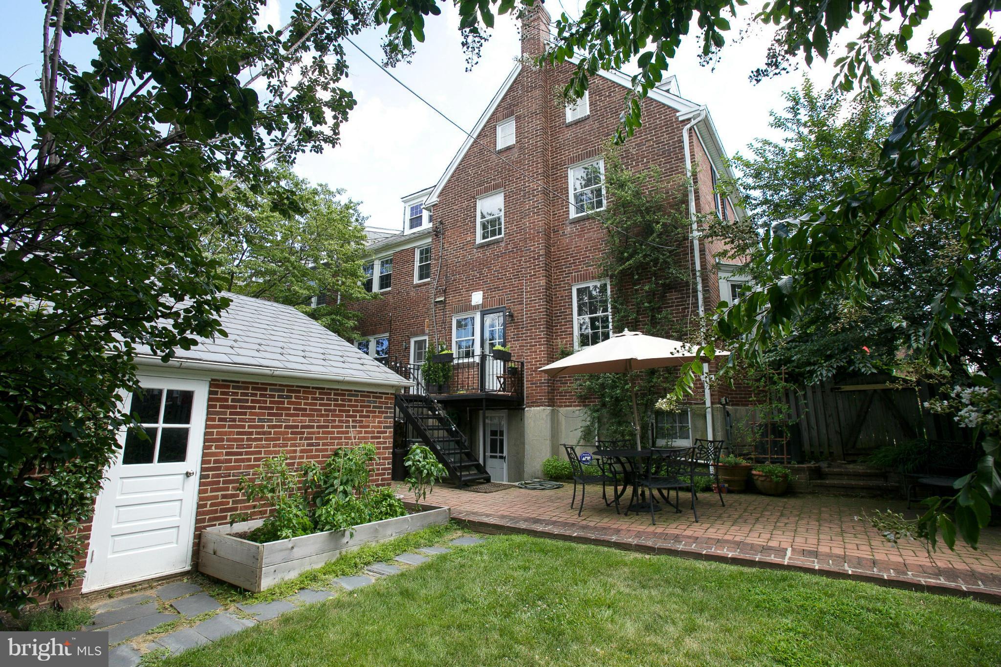 86 Dunkirk Road Baltimore, MD 21212 - Photo 42 of 52 a patio with a table and chairs under an umbrella