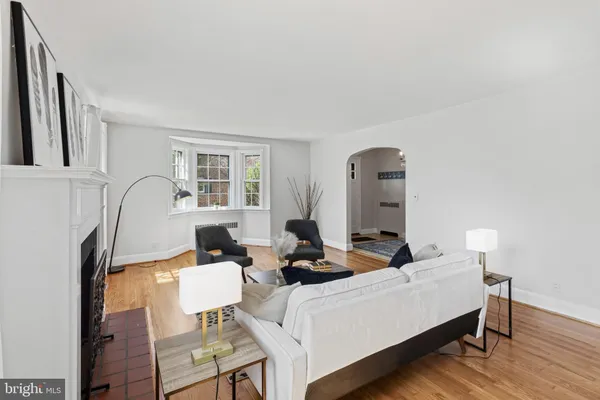 a dining room with wooden floor and window