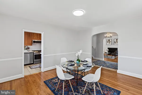 a dining room with furniture and wooden floor