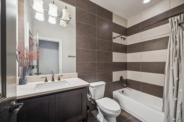 a bathroom with a sink a toilet a mirror and shower