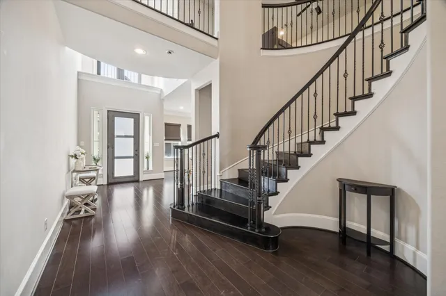 a view of entryway with wooden floor and stairs