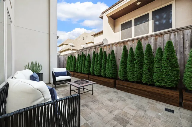 a view of a chair and tables in the balcony