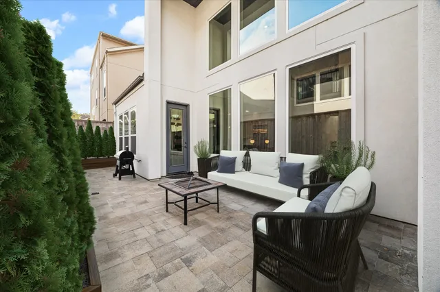 a view of a patio with couches table and chairs and potted plants