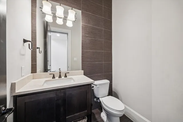 a bathroom with a sink a toilet a mirror and shower