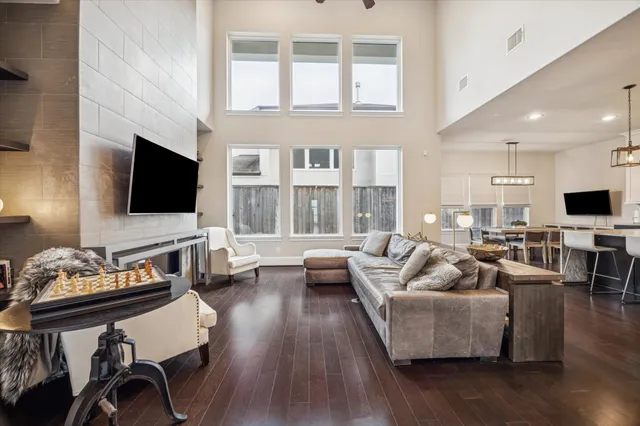 a living room with fireplace furniture and a flat screen tv