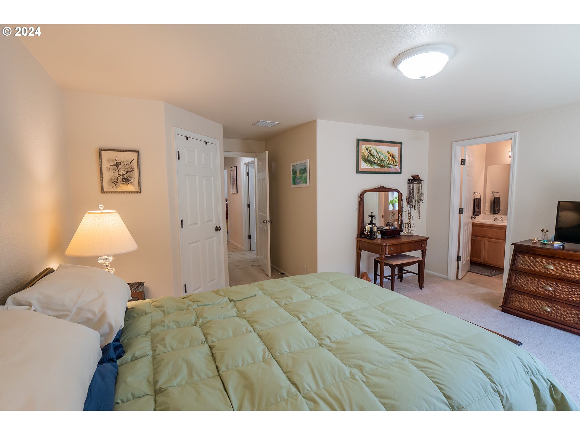 3582 Korbel Street Eugene, OR 97404 - Photo 18 of 32 a bedroom with a bed a chair and painting on the wall