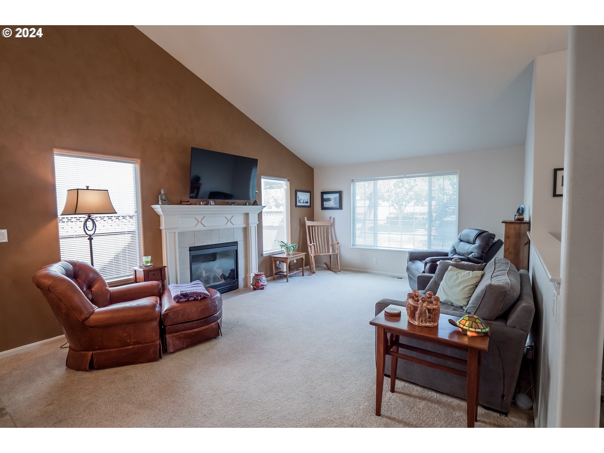 3582 Korbel Street Eugene, OR 97404 - Photo 4 of 32 a living room with furniture a flat screen tv and a fireplace
