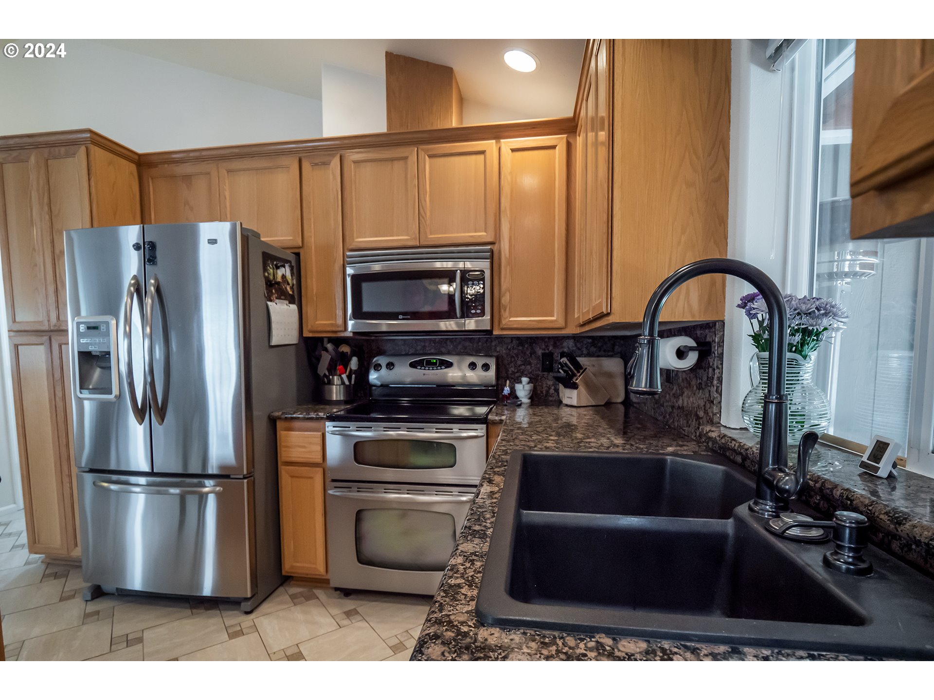 3582 Korbel Street Eugene, OR 97404 - Photo 6 of 32 a kitchen with stainless steel appliances granite countertop a refrigerator and a stove top oven