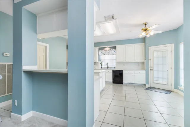 a kitchen with cabinets and window