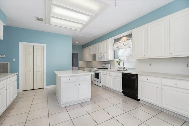 a kitchen with a stove a sink and a refrigerator
