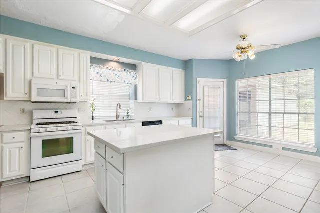a kitchen with a sink stove and cabinets