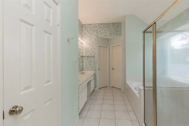 a bathroom with a bathtub and a shower