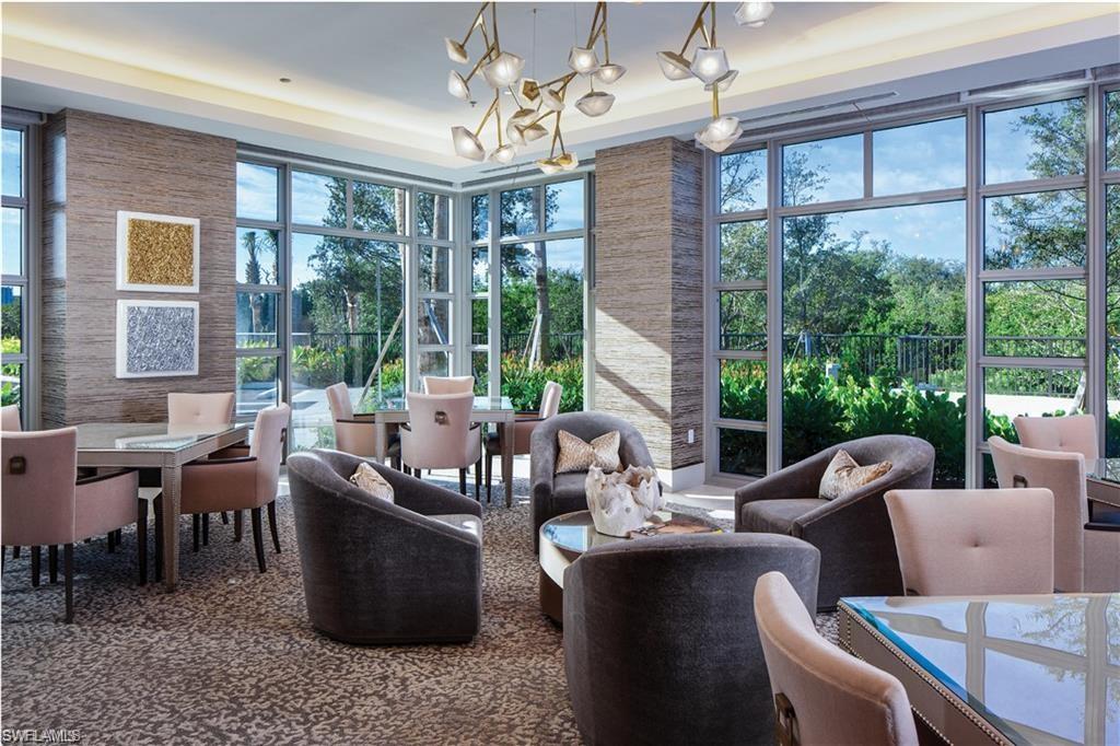 6897 Grenadier Boulevard, Unit 1701 Naples, FL 34108 - Photo 5 of 14 a living room with furniture and a large window
