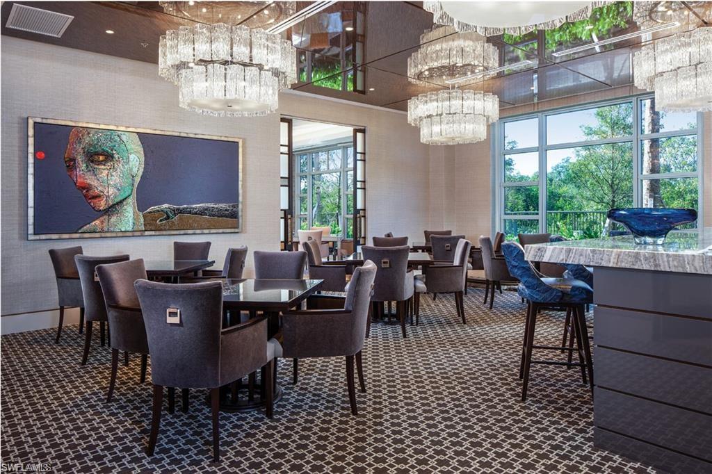 6897 Grenadier Boulevard, Unit 1701 Naples, FL 34108 - Photo 6 of 14 a view of a dining room with furniture a chandelier and window