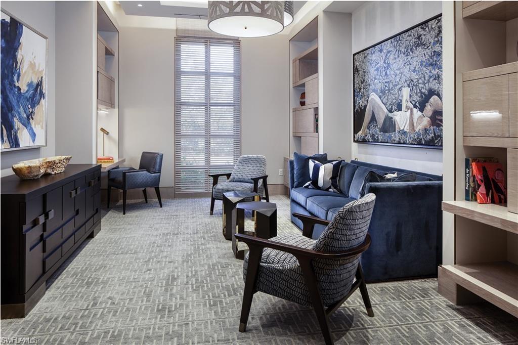 6897 Grenadier Boulevard, Unit 1701 Naples, FL 34108 - Photo 8 of 14 a living room with furniture and a window