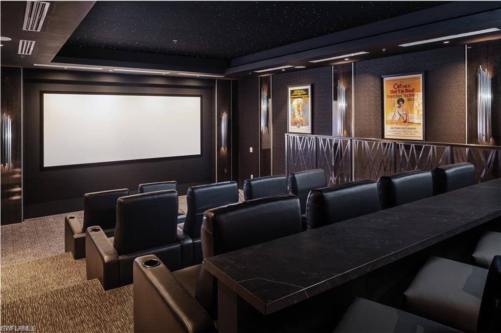 6897 Grenadier Boulevard, Unit 1701 Naples, FL 34108 - Photo 9 of 14 a media room with lots of chairs and a projector