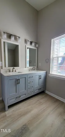 a bathroom with a double vanity sink and mirror