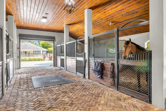 a porch with a table and chairs in front of it