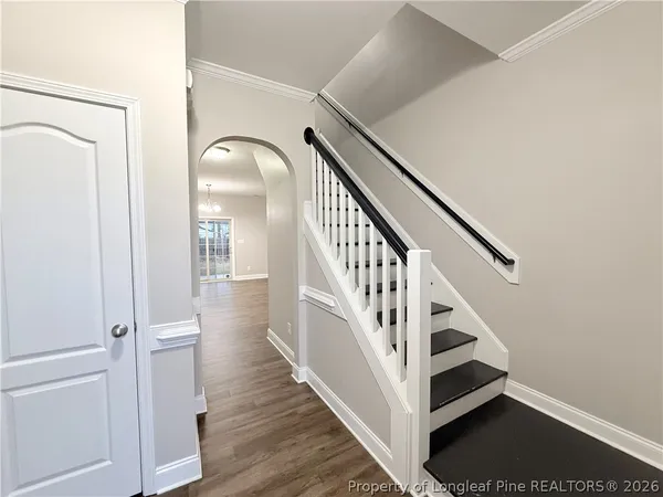 a view of entryway and hall with wooden floor