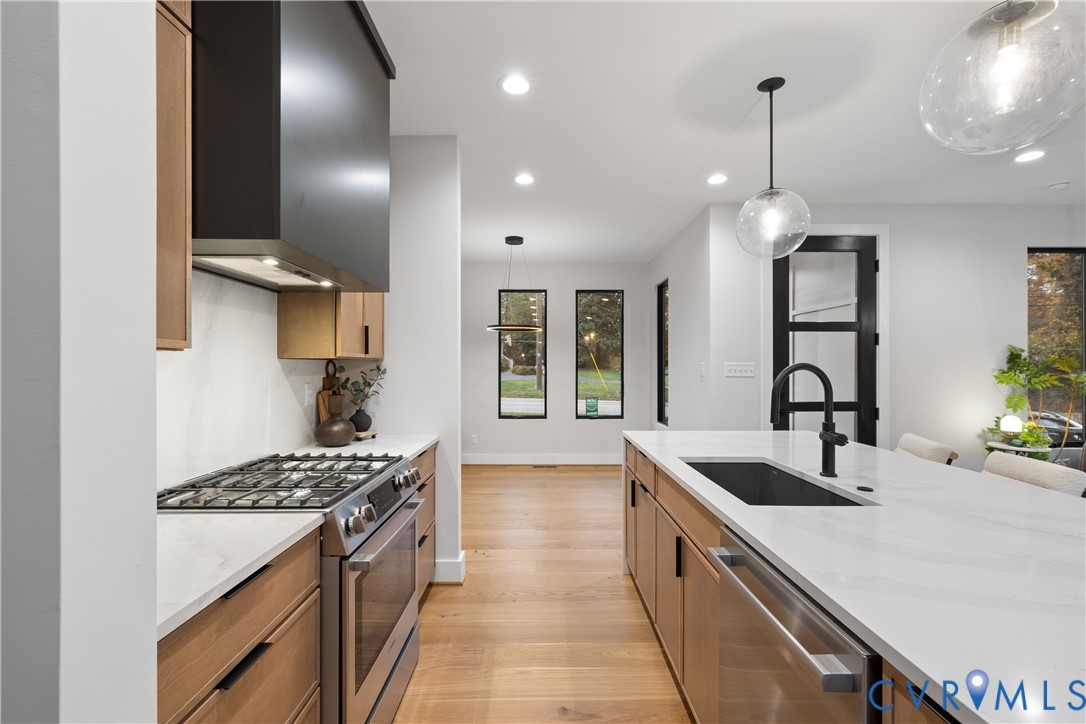 8632 Cherokee Road Richmond, VA 23235 - Photo 11 of 34 a kitchen with stainless steel appliances a sink stove and cabinets