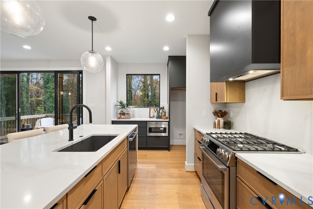8632 Cherokee Road Richmond, VA 23235 - Photo 15 of 34 a kitchen with stainless steel appliances granite countertop a sink stove and refrigerator