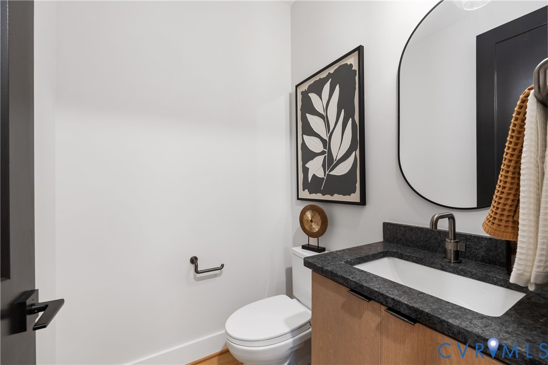 8632 Cherokee Road Richmond, VA 23235 - Photo 17 of 34 a bathroom with a granite countertop sink mirror vanity and toilet