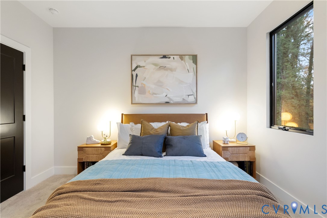 8632 Cherokee Road Richmond, VA 23235 - Photo 26 of 34 a bedroom with a bed and a painting on the wall