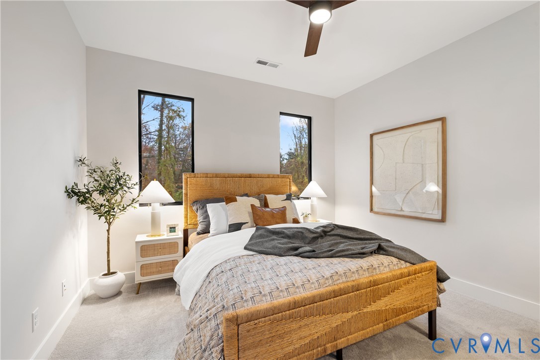 8632 Cherokee Road Richmond, VA 23235 - Photo 29 of 34 a bedroom with a bed and a potted plant