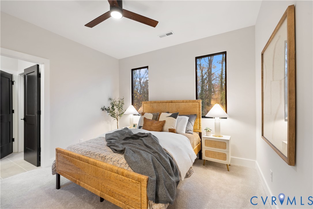 8632 Cherokee Road Richmond, VA 23235 - Photo 30 of 34 a bedroom with a bed and lamp with window