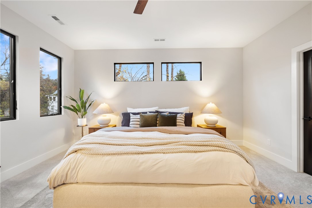 8632 Cherokee Road Richmond, VA 23235 - Photo 33 of 34 a bedroom with a bed and a painting on the wall