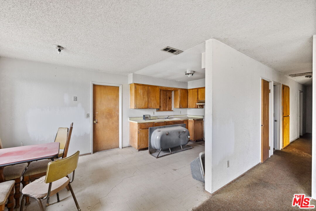 1112 Valencia Avenue Delano, CA 93215 - Photo 13 of 55 a bedroom with a bed and wooden floor