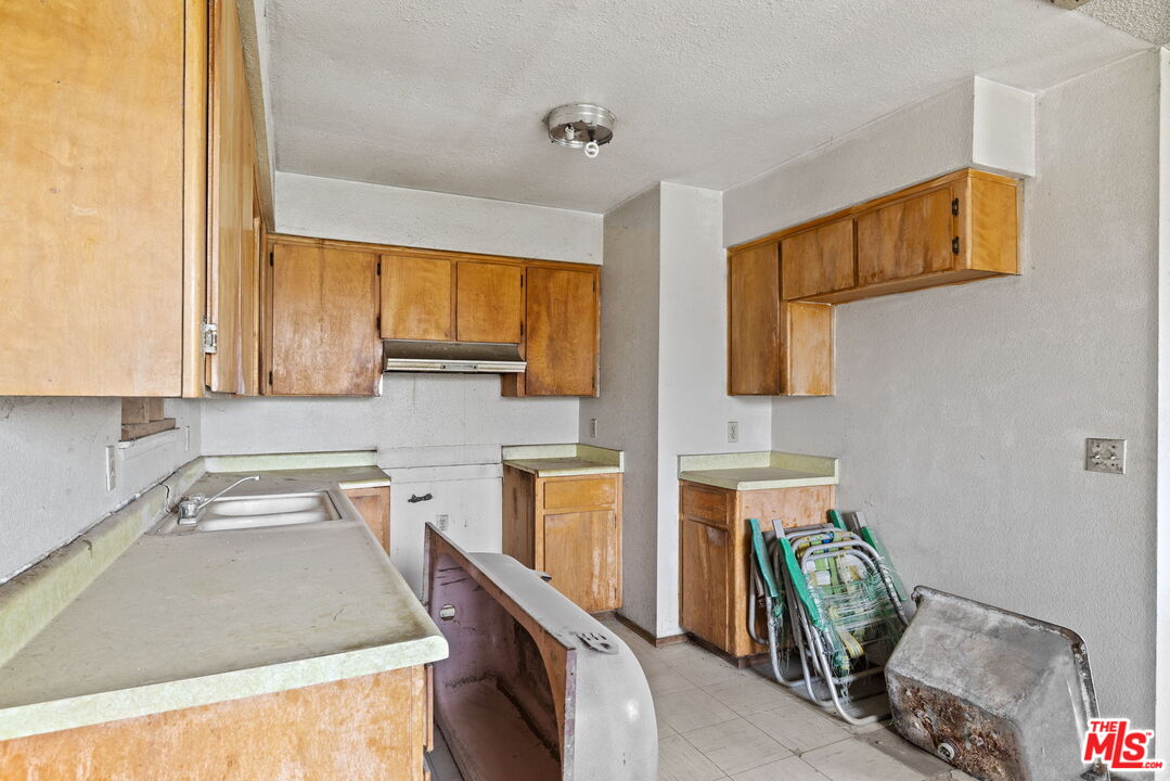 1112 Valencia Avenue Delano, CA 93215 - Photo 19 of 55 a kitchen with stainless steel appliances granite countertop a sink and a stove
