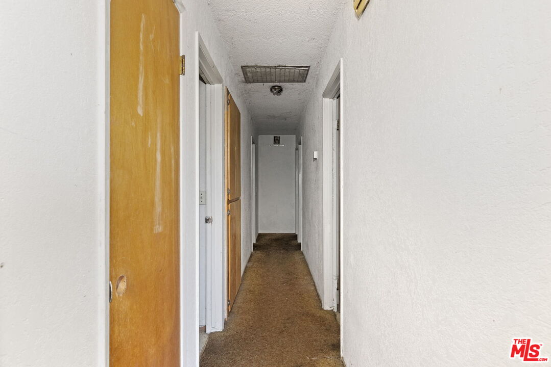 1112 Valencia Avenue Delano, CA 93215 - Photo 23 of 55 a view of a hallway with a wooden door