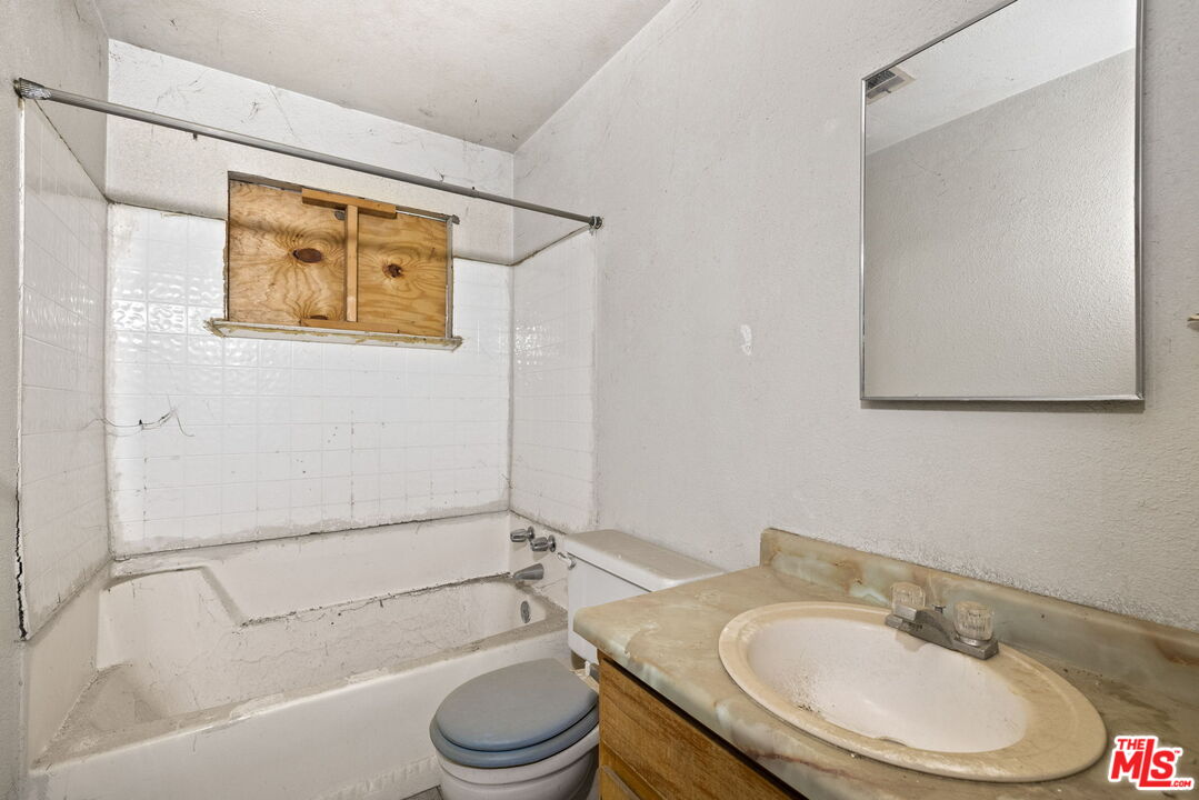 1112 Valencia Avenue Delano, CA 93215 - Photo 26 of 55 a bathroom with a sink and a mirror