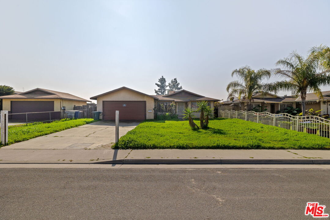 1112 Valencia Avenue Delano, CA 93215 - Photo 49 of 55 a front view of a house with a garden and plants