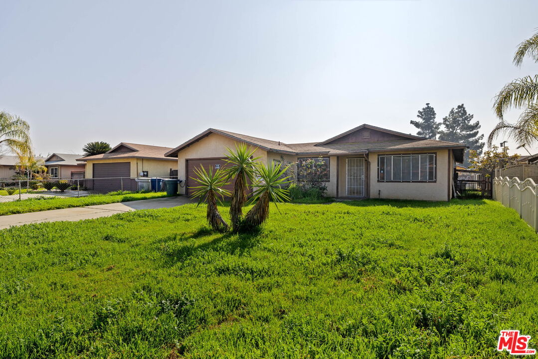 1112 Valencia Avenue Delano, CA 93215 - Photo 50 of 55 a view of a house with a big yard and large trees