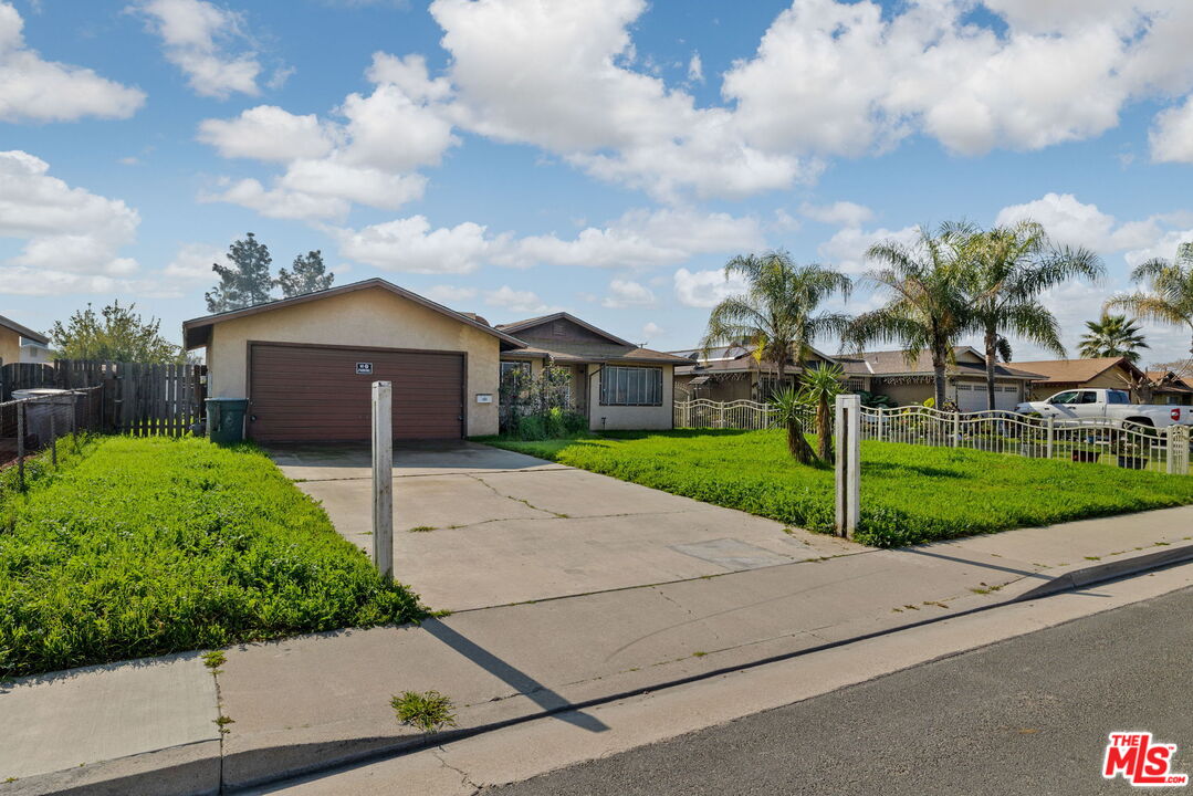 1112 Valencia Avenue Delano, CA 93215 - Photo 5 of 55 a house with green field in front of it