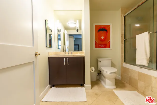 a bathroom with a toilet sink and shower